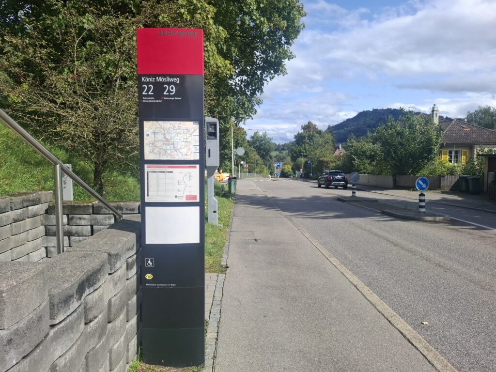 “Waiting for the bus at a bus stop”