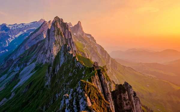 Panoramic sunset view over the Alpstein mountains in Appenzell, Switzerland.
