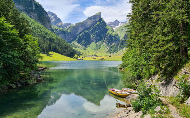 Serene mountain lake Seealpsee in the Alpstein Alps, Switzerland.